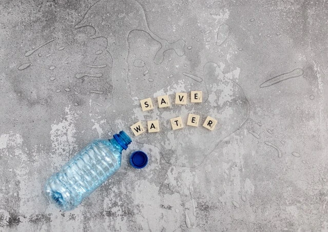 Plastic water bottle with save water message representing water conservation