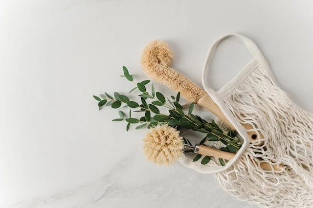 Eco-friendly cleaning supplies and reusable shopping bag for sustainable living