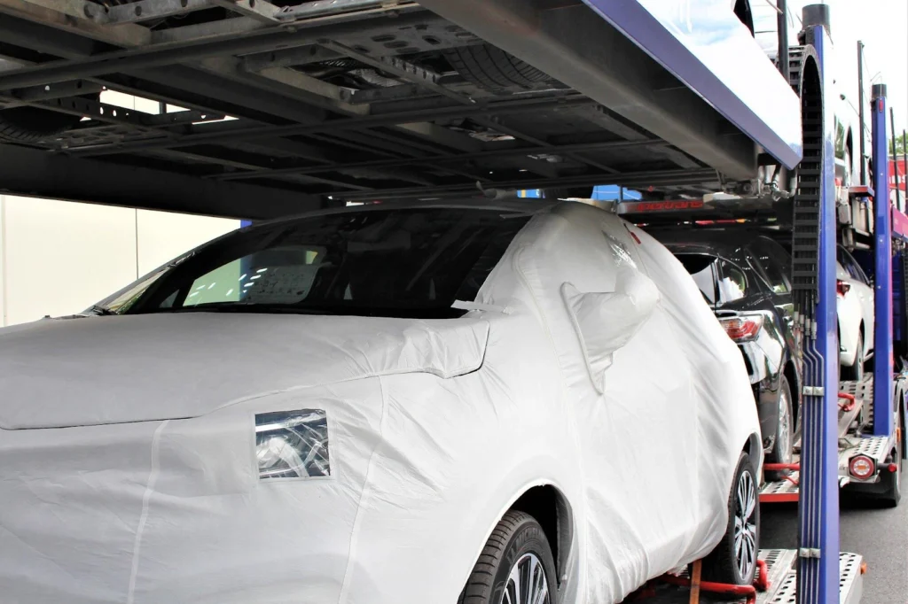 Streamline auto transport service loading a car onto a professional vehicle carrier for safe and efficient shipping