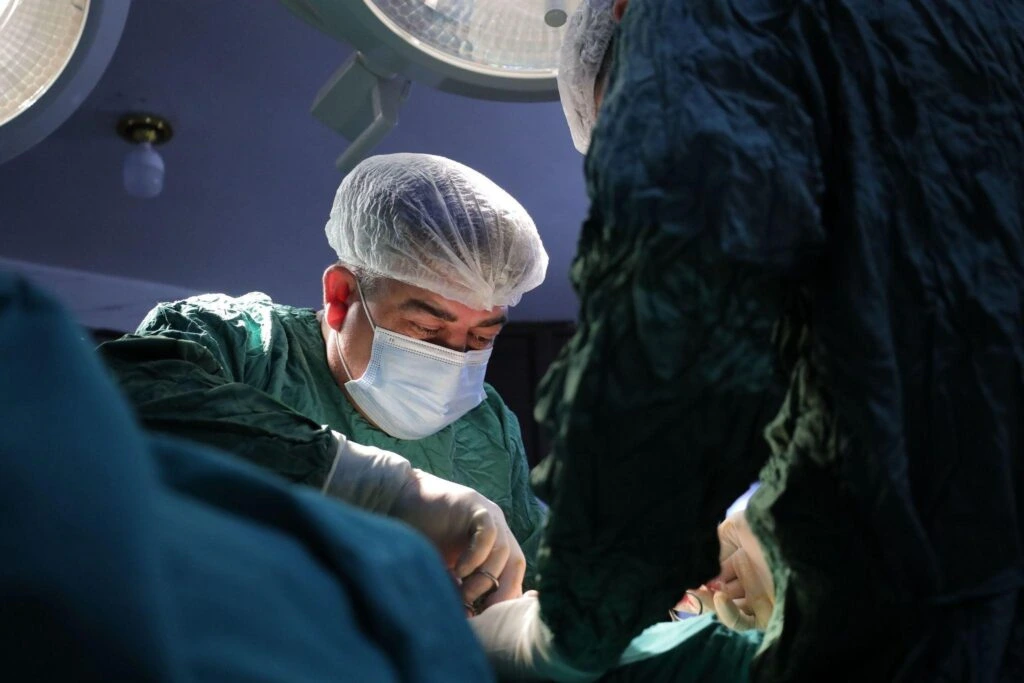 Board-certified plastic surgeon performing a cosmetic surgery procedure in an accredited operating room