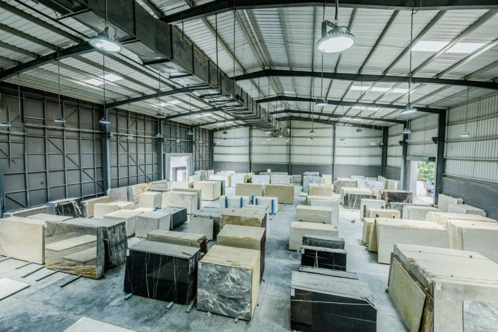 Modern warehouse storing large marble and stone slabs with organized inventory for efficient distribution and logistics.