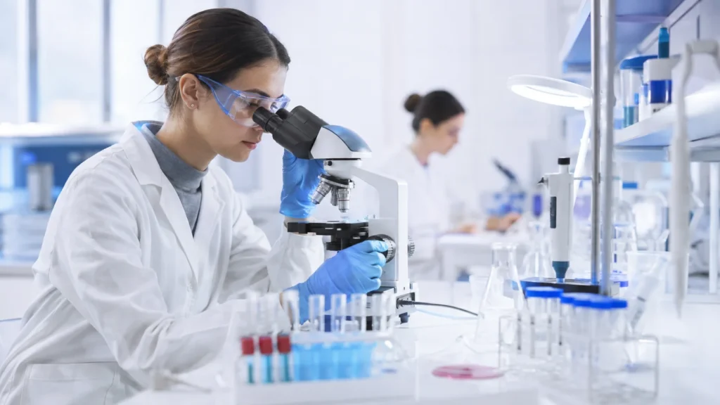 Scientist conducting biotechnology research with a microscope in a modern laboratory