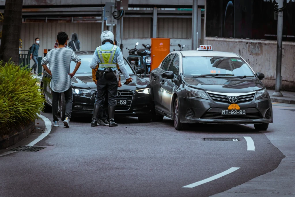 Police officer investigating a car accident involving two vehicles on a city street