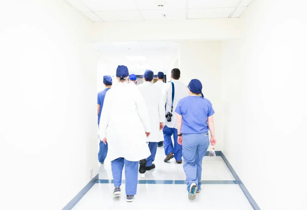 Healthcare professionals walking through a hospital wearing modern ergonomic and comfort-focused medical apparel in 2026.