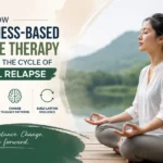 A woman practicing mindfulness meditation outdoors, illustrating how Mindfulness-Based Cognitive Therapy (MBCT) helps break the cycle of habitual relapse, reduce cravings, and build long-term emotional resilience.
